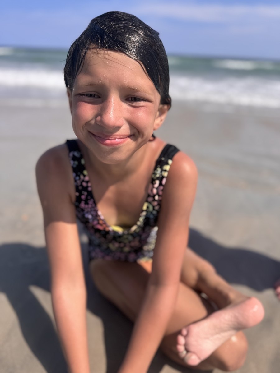 Belle smiling on the beach after a swim