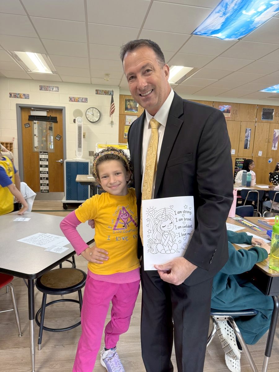 Belle with Harborfields Superintendent Dr. Rory Manning on a school visit