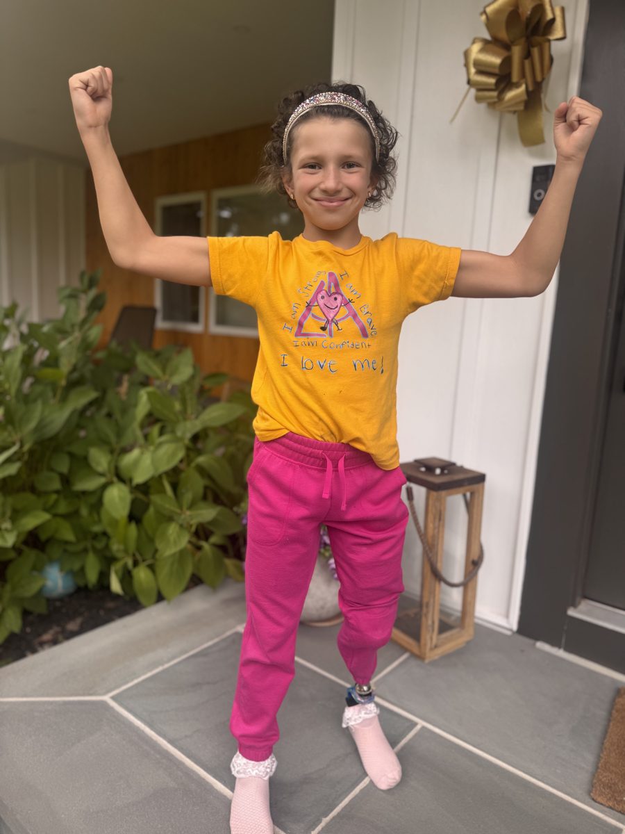 Belle flexing in her gold I am strong t-shirt