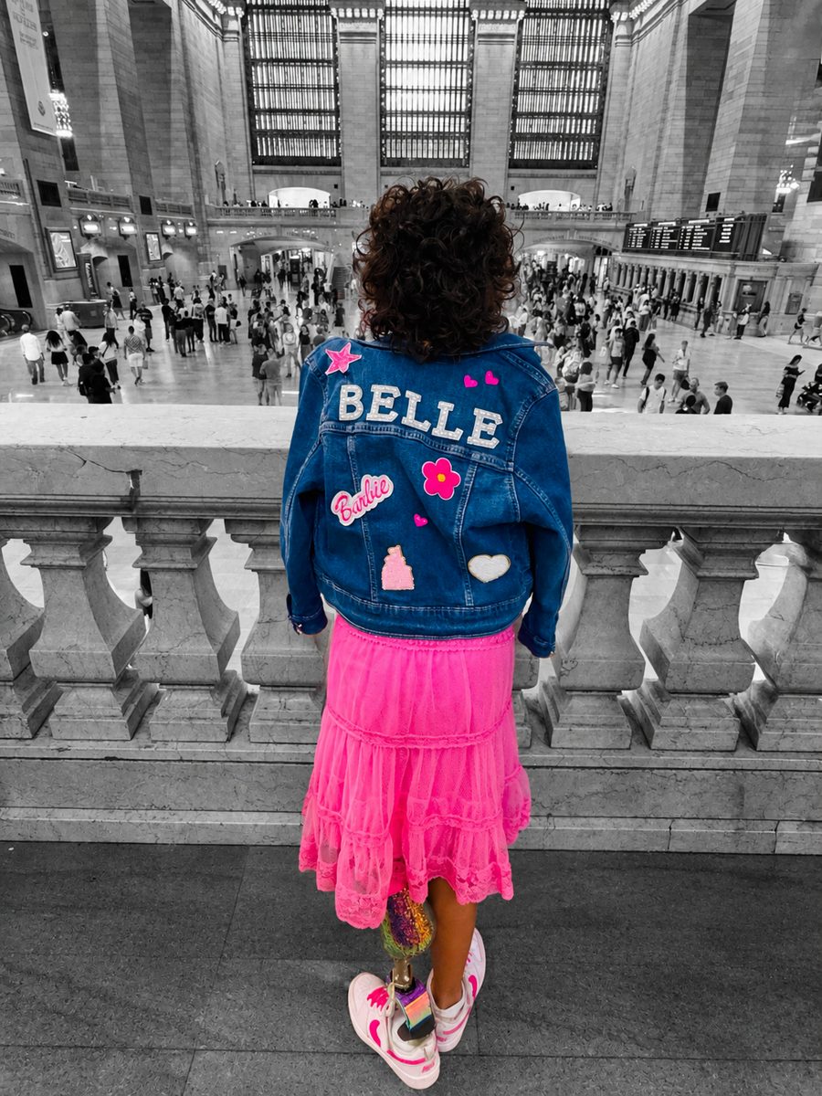 Belle from behind in a BELLE denim jacket at Grand Central