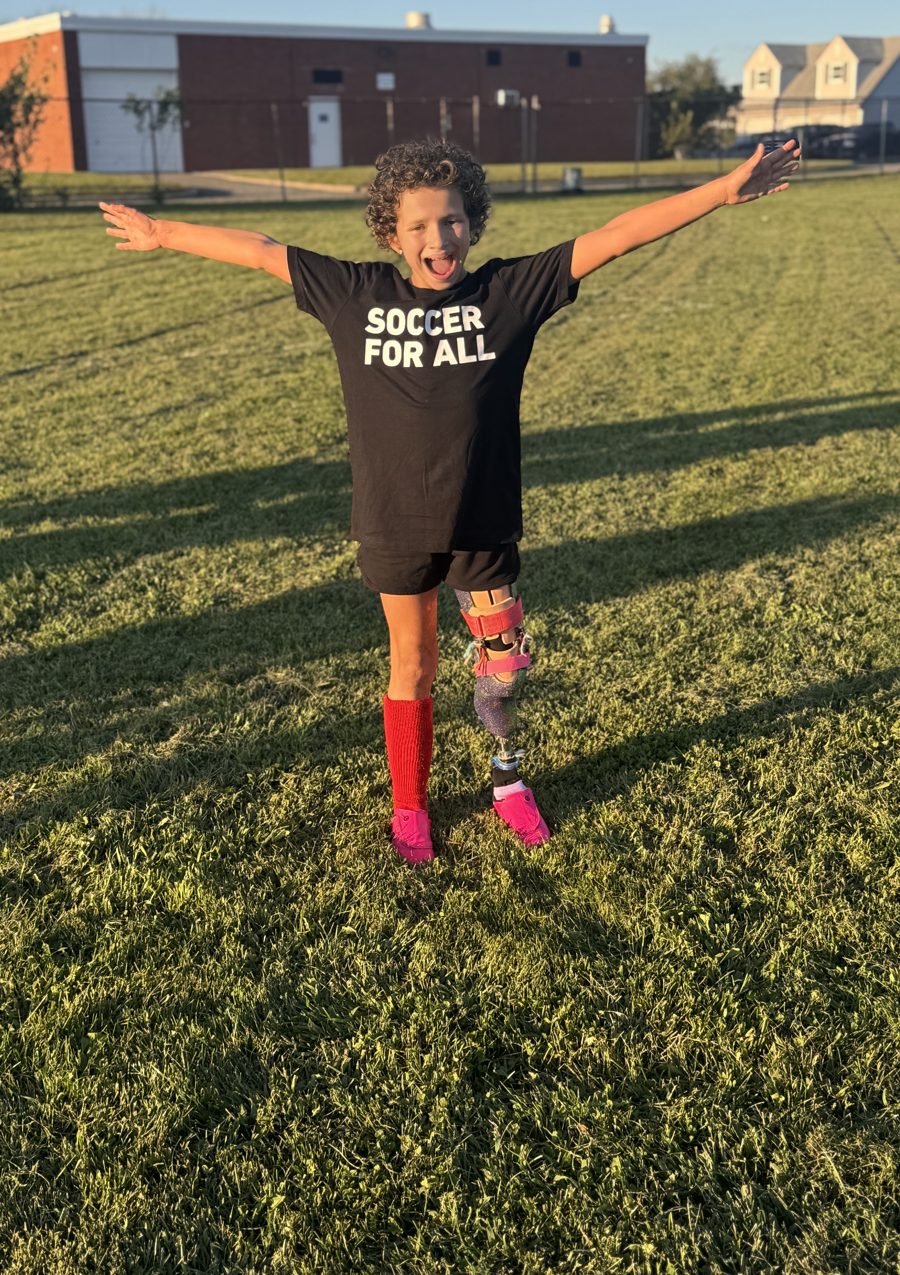 Belle on a soccer field in a Soccer For All shirt