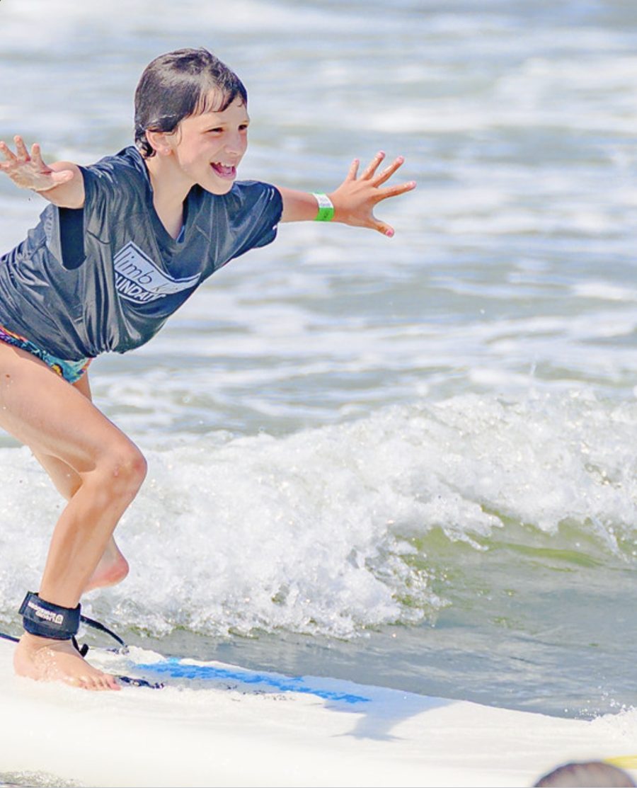 Belle surfing with her arms out